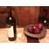 Still life with apples, wine, and a crayon.